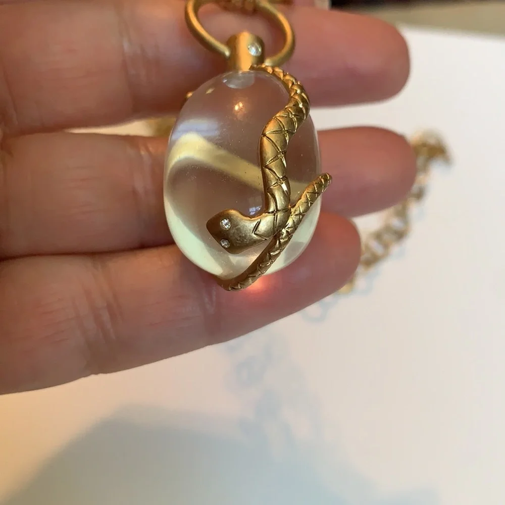 Vintage golden Snake wrapped around an elongated oval crystal